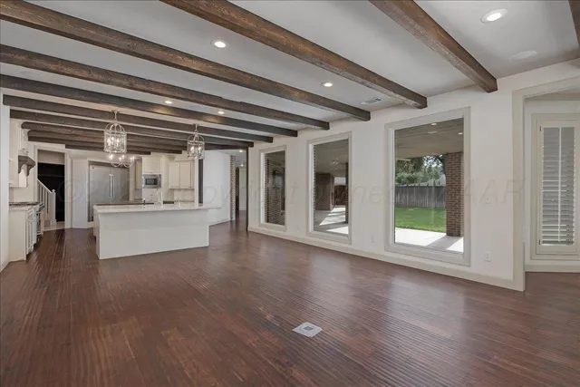 an empty room with a empty space and windows