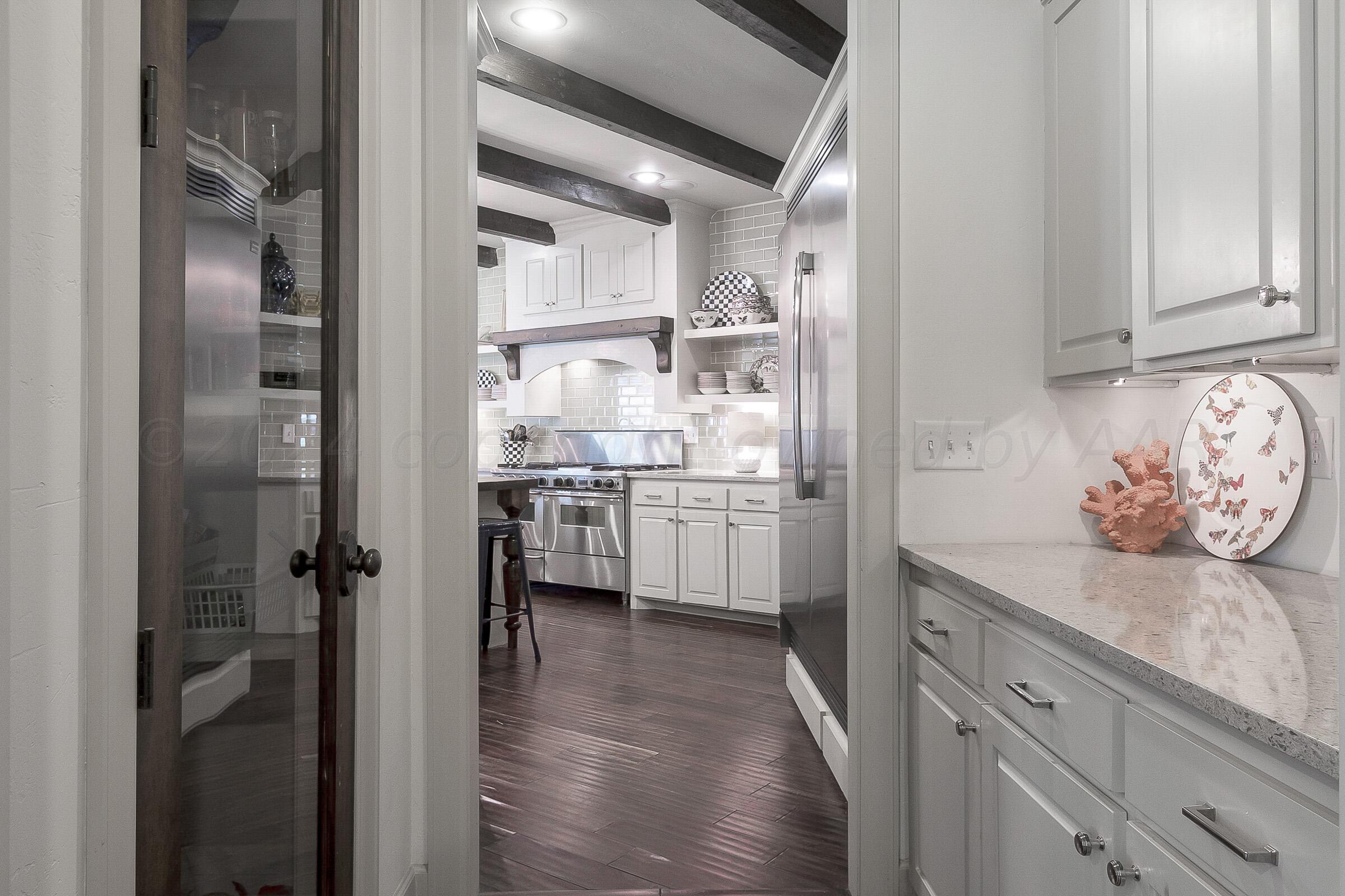 6107 Blue Sage Circle Amarillo, TX 79124 - Photo 25 of 79 a kitchen with a refrigerator and white cabinets