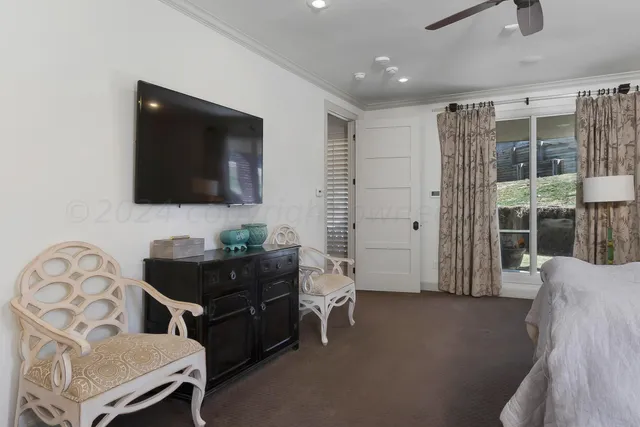 a living room with furniture and a ceiling fan