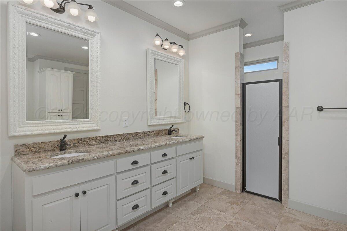 6107 Blue Sage Circle Amarillo, TX 79124 - Photo 36 of 79 a bathroom with a granite countertop double vanity sink and mirror