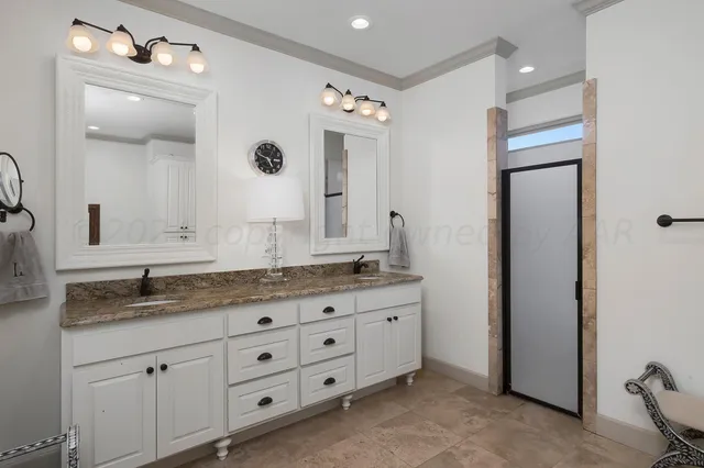 a bathroom with a sink a large mirror and a bathtub