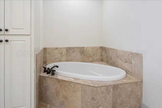 en empty room with fan and a flat screen tv