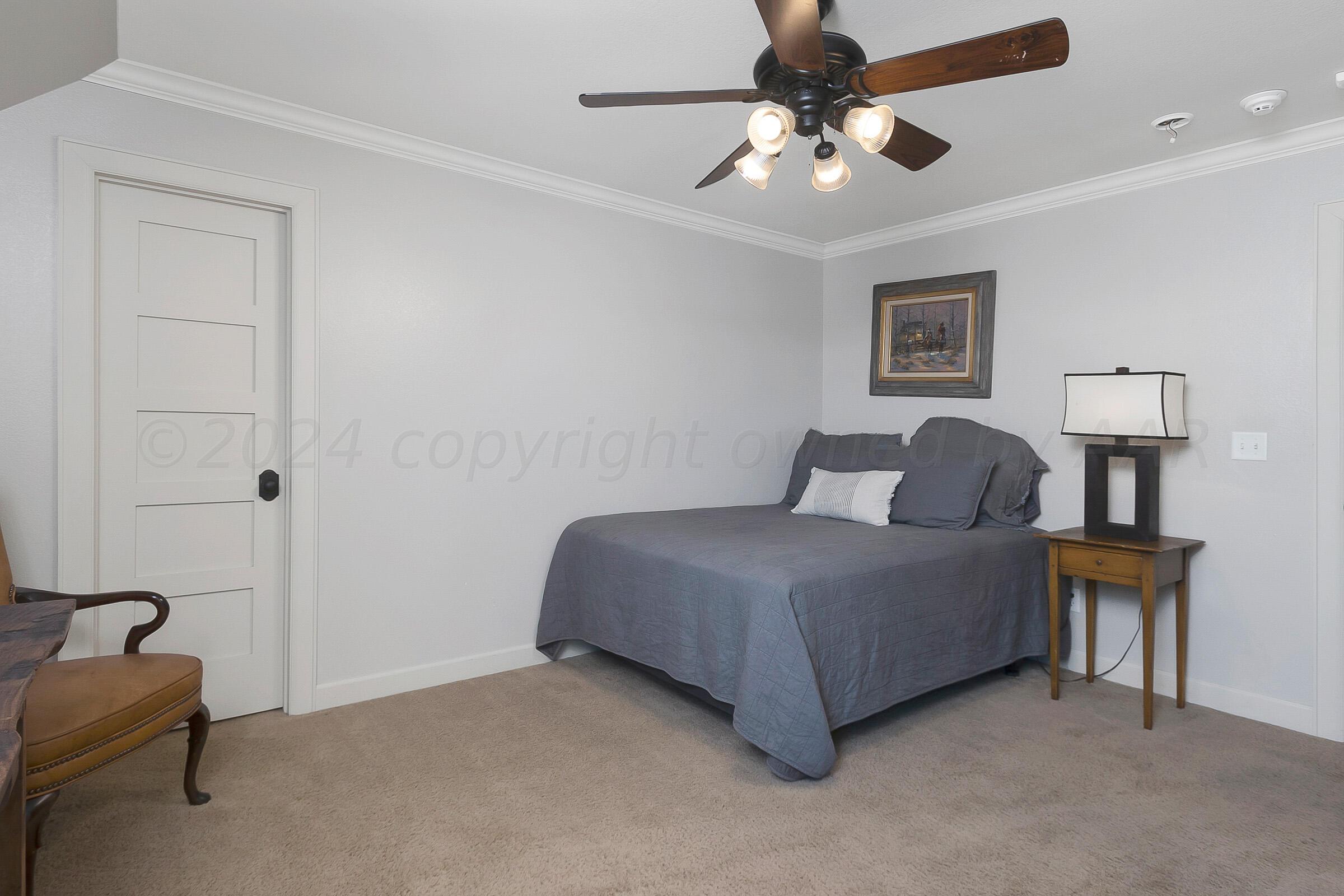 6107 Blue Sage Circle Amarillo, TX 79124 - Photo 58 of 79 a bedroom with a bed and a chandelier