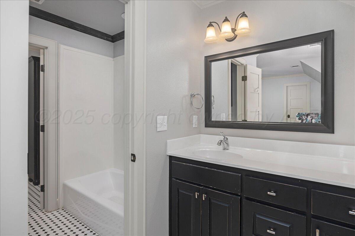 6107 Blue Sage Circle Amarillo, TX 79124 - Photo 59 of 79 a bathroom with a sink a large mirror and a bathtub