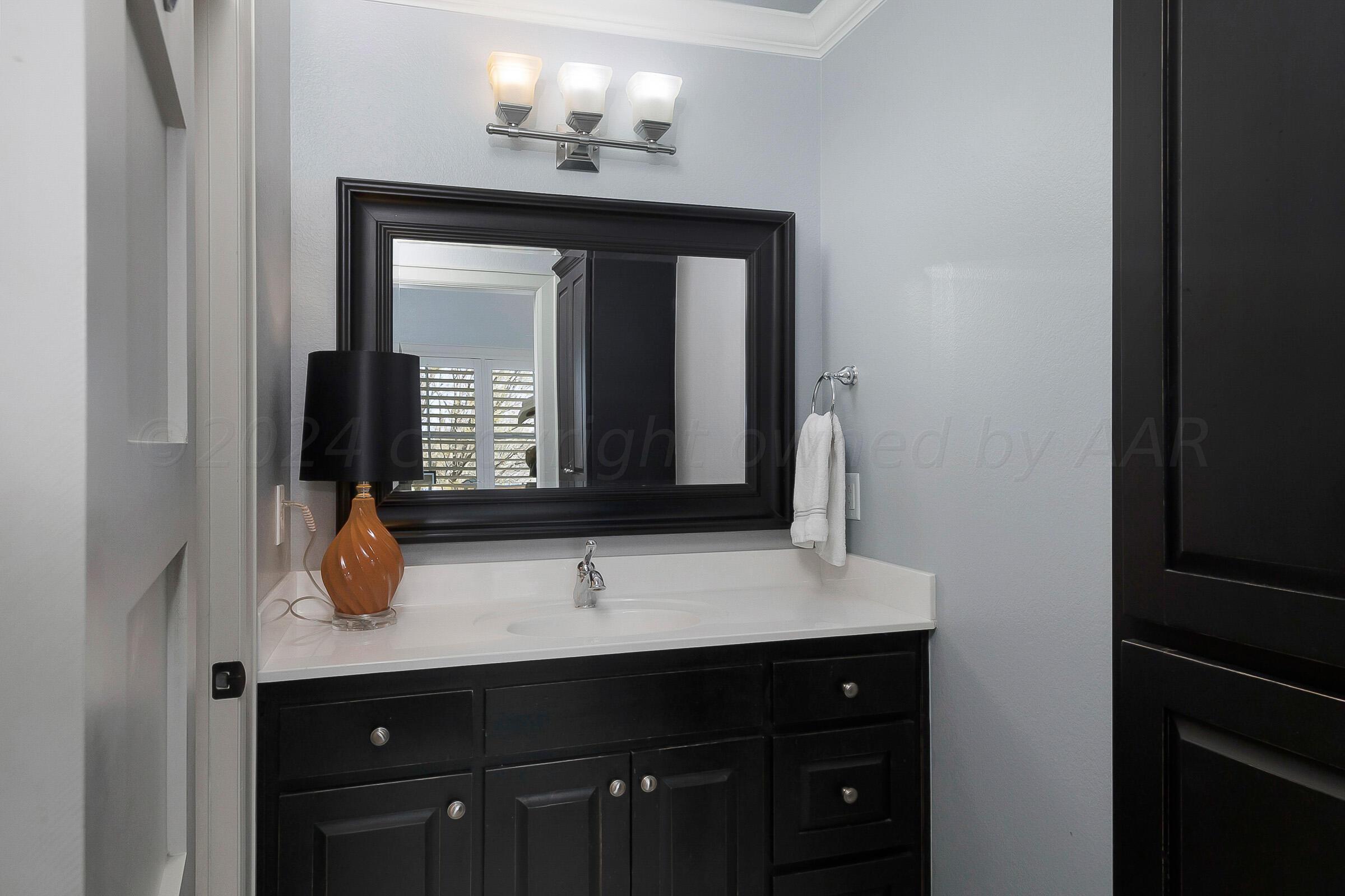 6107 Blue Sage Circle Amarillo, TX 79124 - Photo 65 of 79 a bathroom with a sink and a mirror