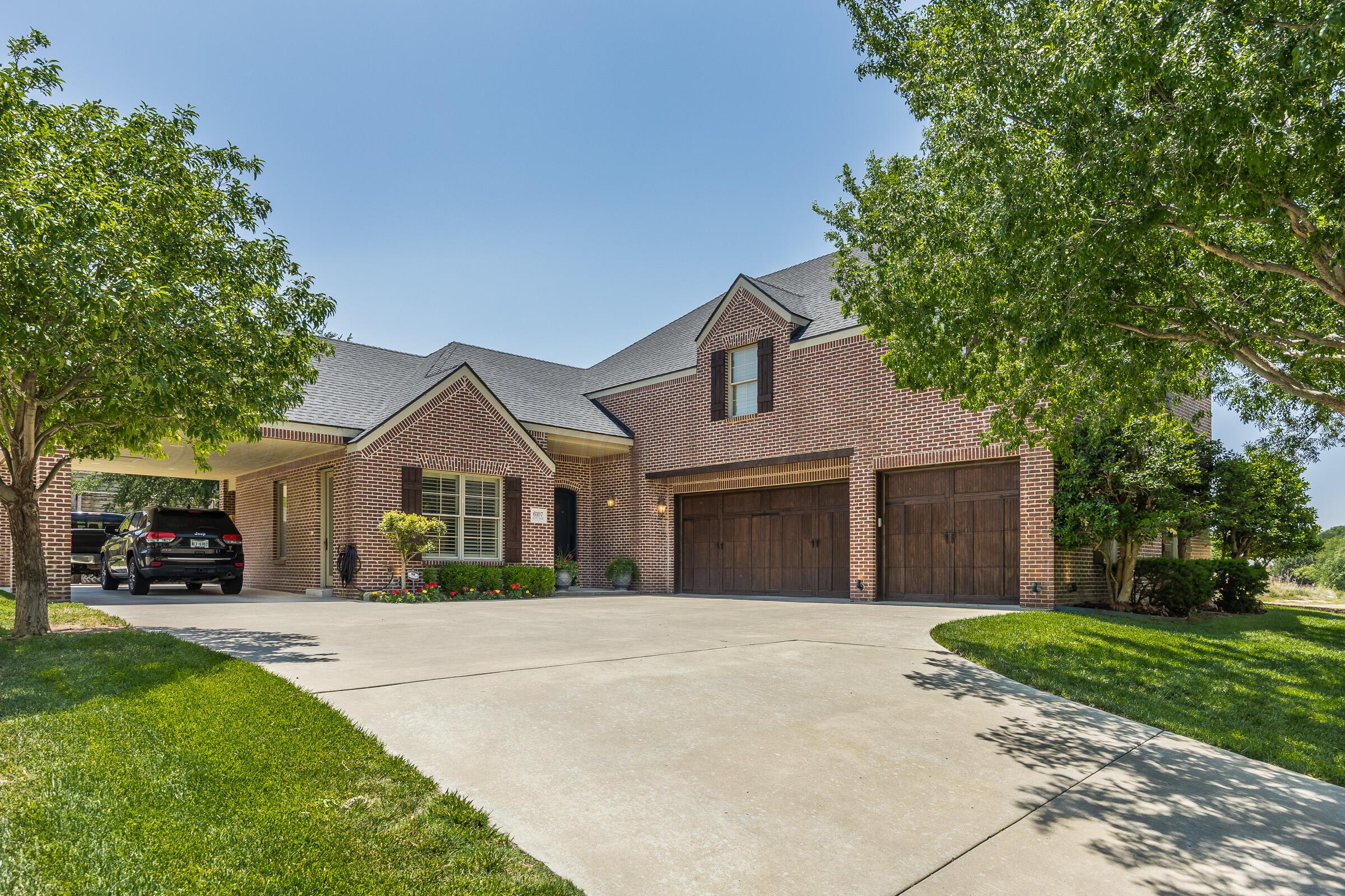 6107 Blue Sage Circle Amarillo, TX 79124 - Photo 79 of 79 a front view of a house with a garden and trees