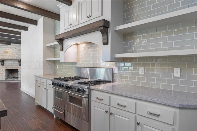 a kitchen with stainless steel appliances granite countertop a stove and a refrigerator