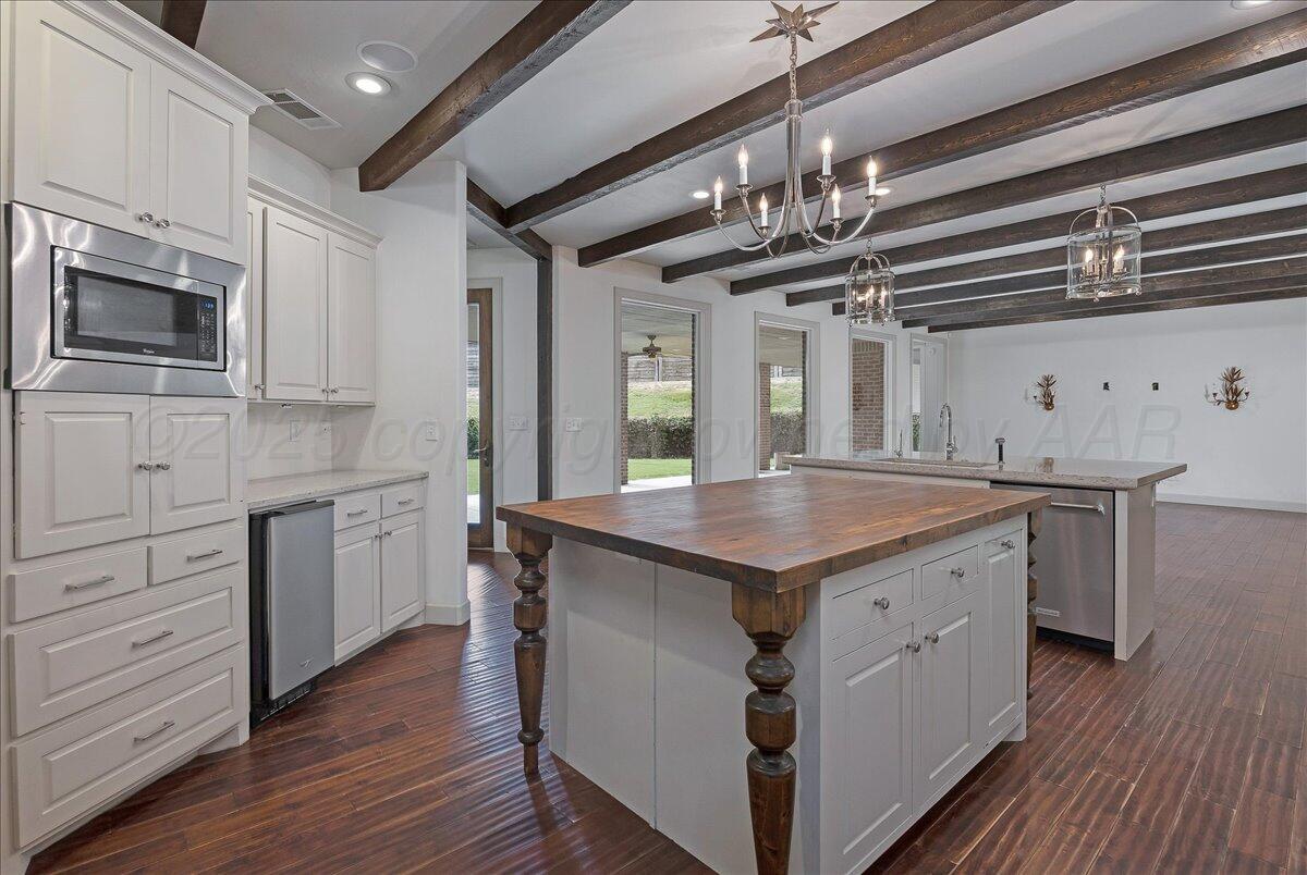 6107 Blue Sage Circle Amarillo, TX 79124 - Photo 10 of 79 a kitchen with stainless steel appliances granite countertop a kitchen island a stove and a wooden floors