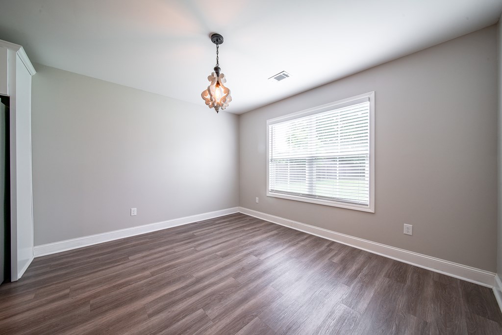 16 Maxwell Drive Fort Mitchell, AL 36856 - Photo 20 of 25 an empty room with wooden floor and windows