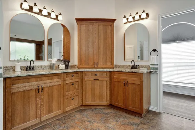 a bathroom with a double vanity sink and a mirror