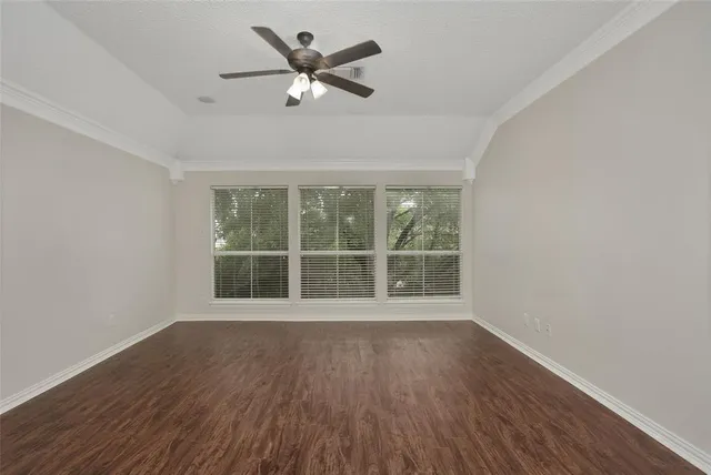 a view of wooden floor and a chandelier fan in a room