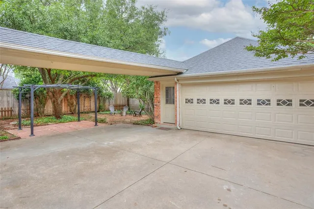 a backyard of a house with table and chairs