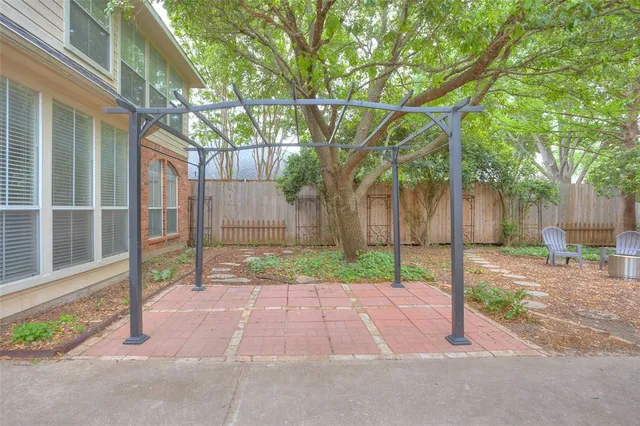 a backyard of a house with table and chairs