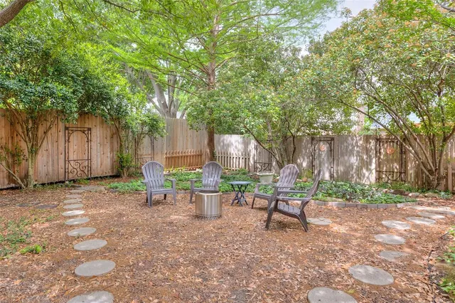 a backyard of a house with table and chairs