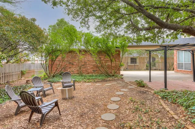 a view of backyard of house with seating space