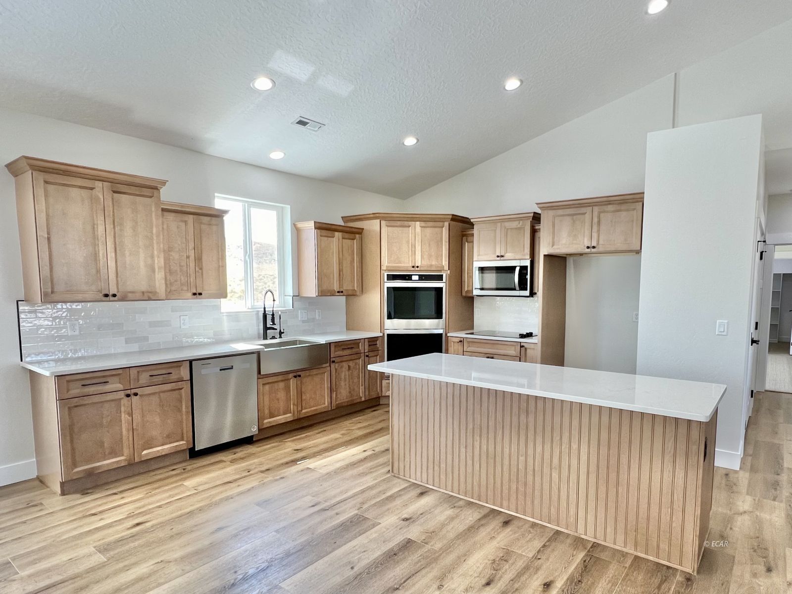 610 Ridgeway Drive Spring Creek, NV 89815 - Photo 2 of 33 a large kitchen with stainless steel appliances granite countertop a large counter top and wooden floors