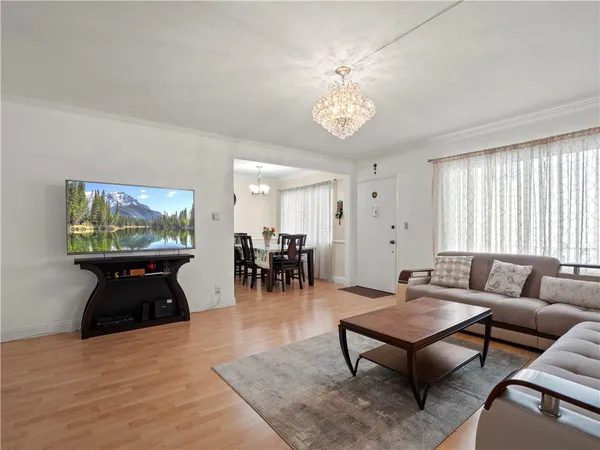 a living room with furniture a table and a large window
