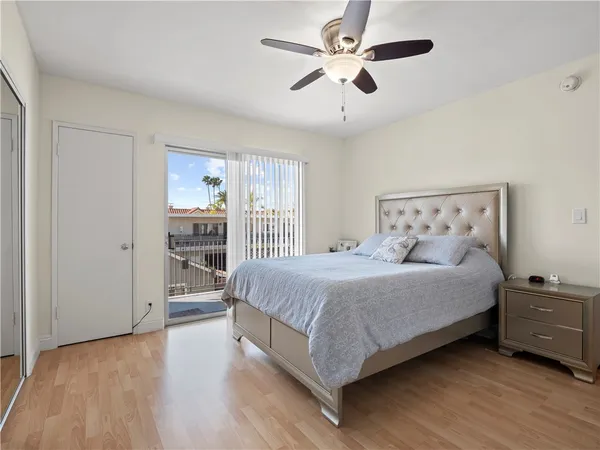 a spacious bedroom with a bed and a chandelier
