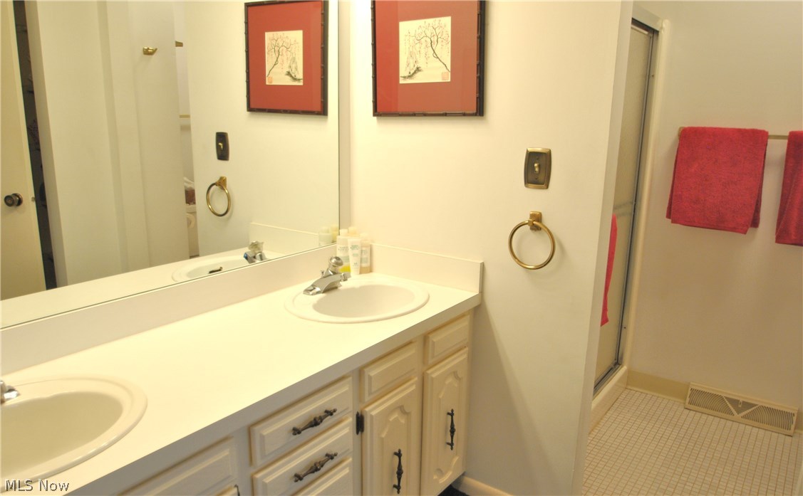 517 Hampton Ridge Drive Akron, OH 44313 - Photo 11 of 19 The en suite bath has a double vanity and private shower and commode area.