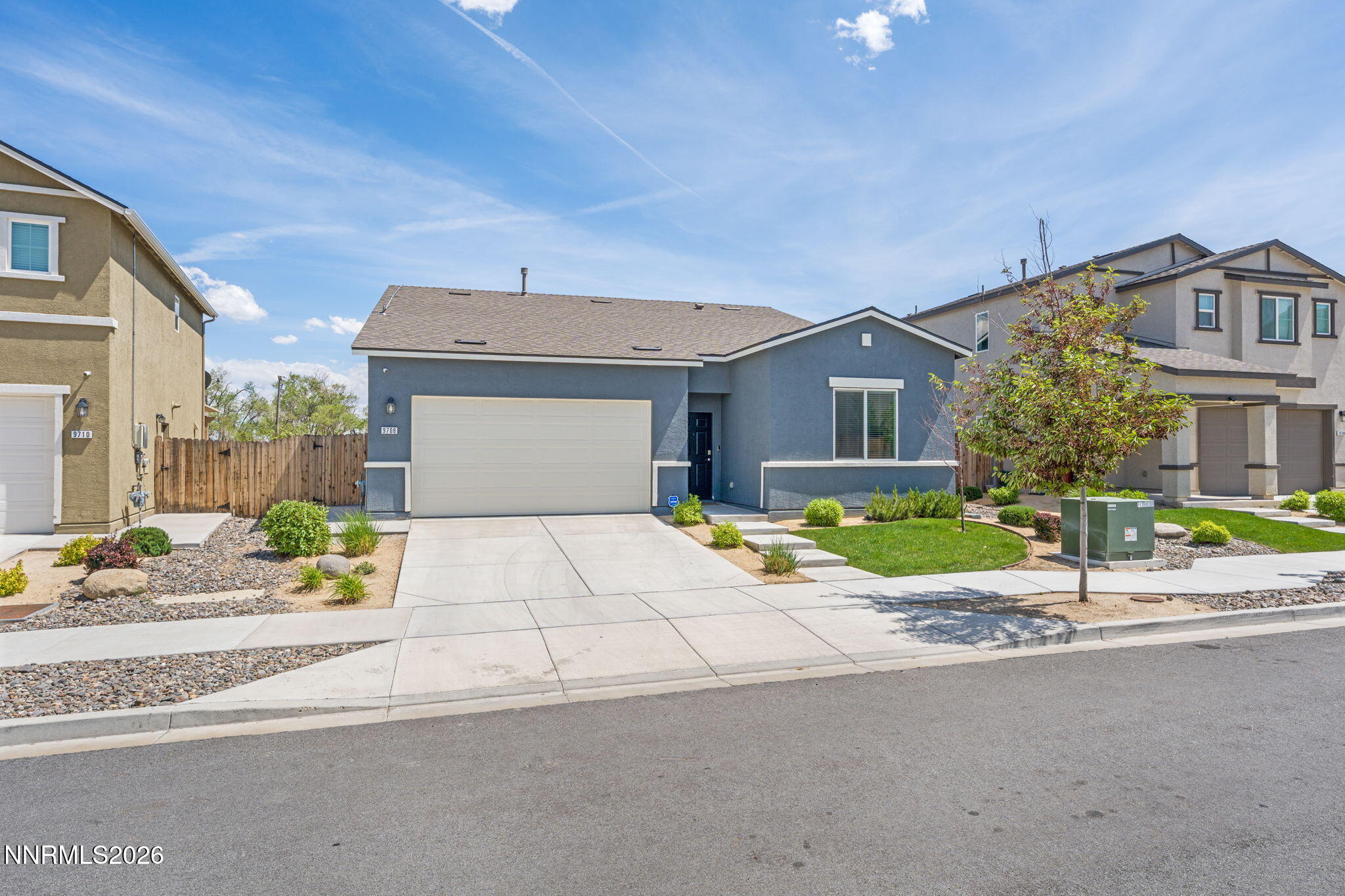 9708 Sea Glass Drive Reno, NV 89506 - Photo 2 of 51 a front view of a house with a yard and garage