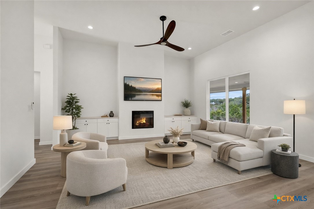 328 Compass Rose Spring Branch, TX 78070 - Photo 11 of 48 a living room with furniture flat screen tv and a fireplace