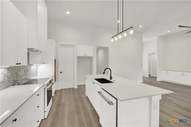 a bathroom with a granite countertop sink a toilet and a mirror