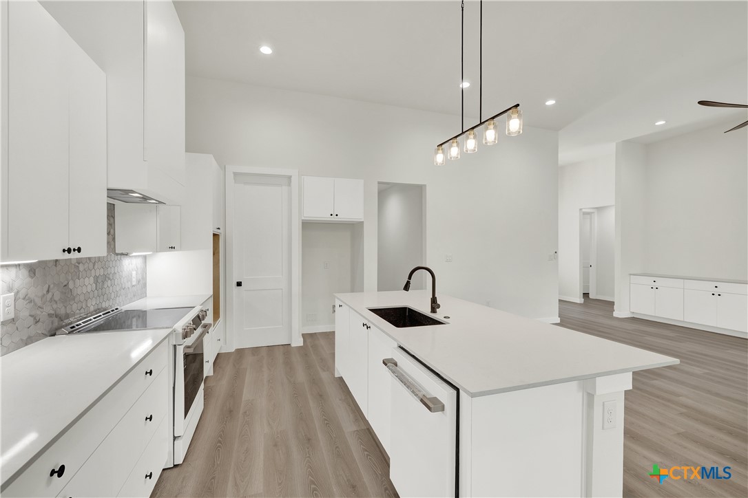 328 Compass Rose Spring Branch, TX 78070 - Photo 16 of 48 a kitchen that has a lot of cabinets and wooden floor