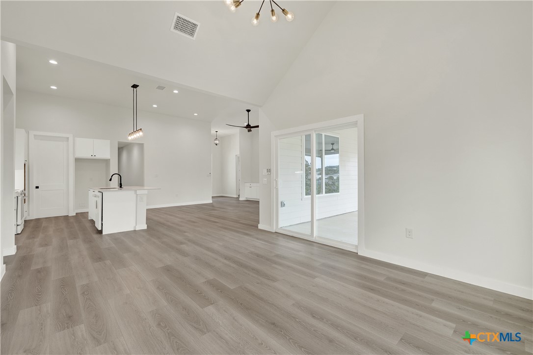 328 Compass Rose Spring Branch, TX 78070 - Photo 20 of 48 a view of empty room with wooden floor and windows