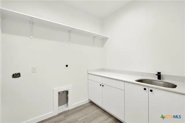 an empty room with wooden floor and ceiling fan