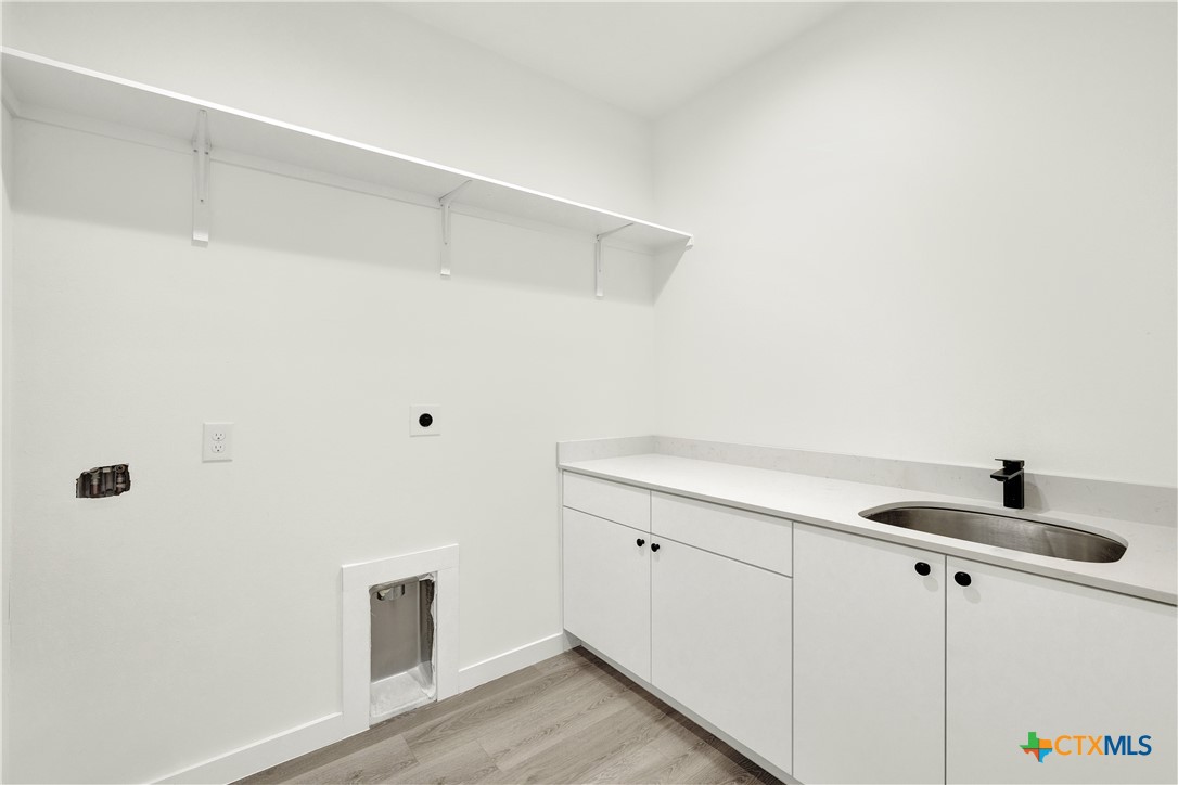 328 Compass Rose Spring Branch, TX 78070 - Photo 24 of 48 a kitchen with a sink and cabinets