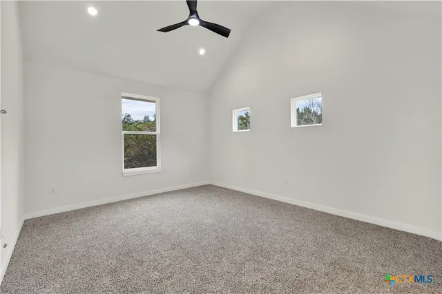 a bathroom with a bathtub shower sink mirror vanity and toilet