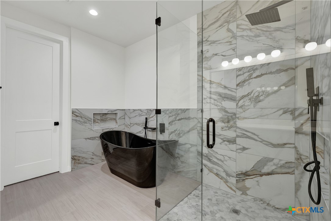 328 Compass Rose Spring Branch, TX 78070 - Photo 28 of 48 a bathroom with a bathtub and shower