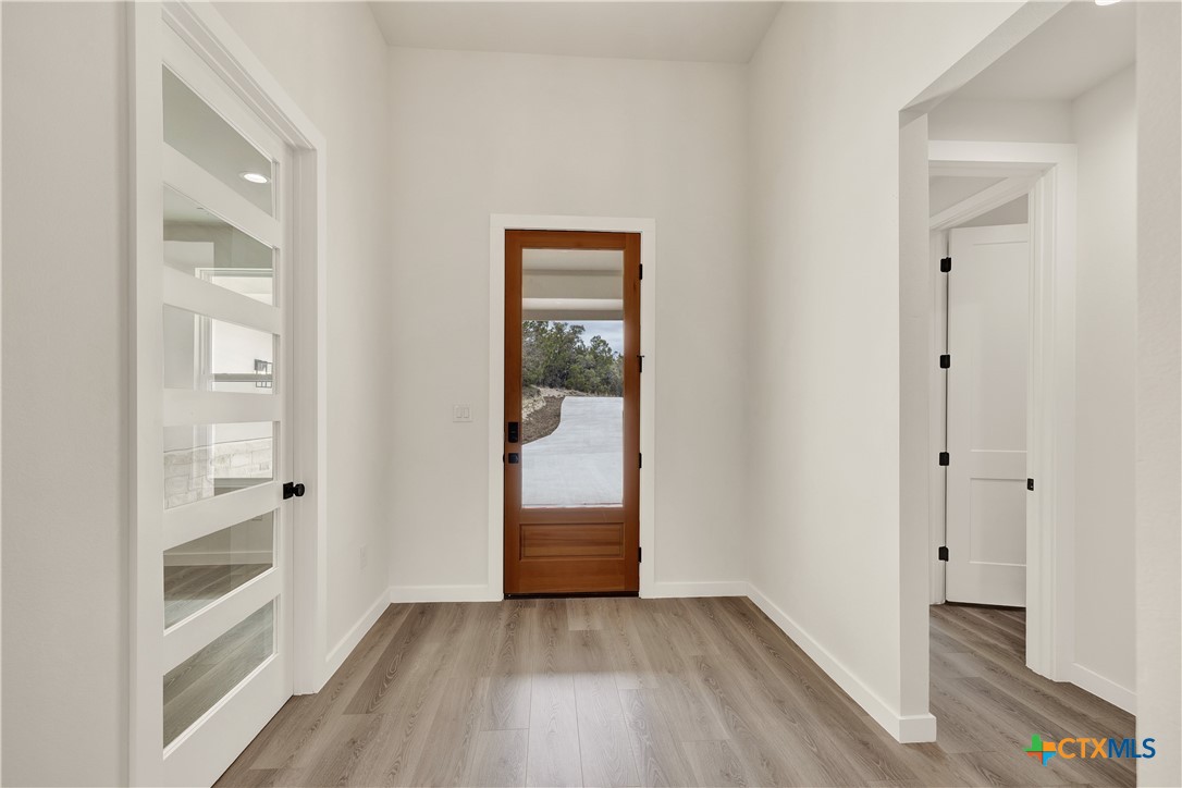 328 Compass Rose Spring Branch, TX 78070 - Photo 4 of 48 a view of a hallway with wooden floor and closet