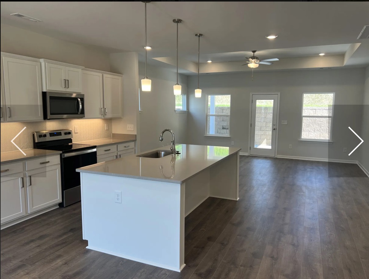 7147 Pepper Tree Circle Fairview, TN 37062 - Photo 2 of 6 a kitchen with stainless steel appliances kitchen island granite countertop a sink a stove top oven a counter space and cabinets