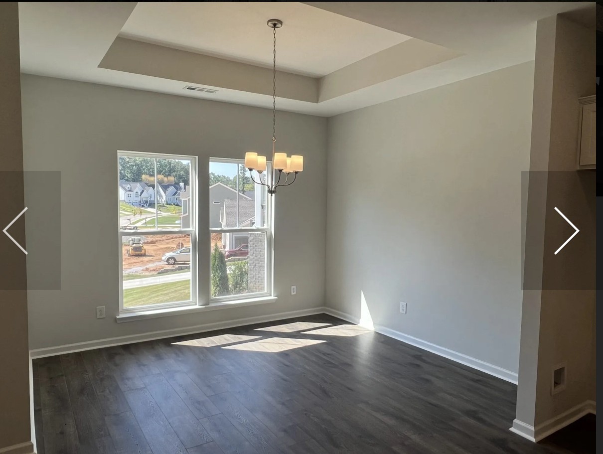 7147 Pepper Tree Circle Fairview, TN 37062 - Photo 5 of 6 an empty room with wooden floor chandelier and windows