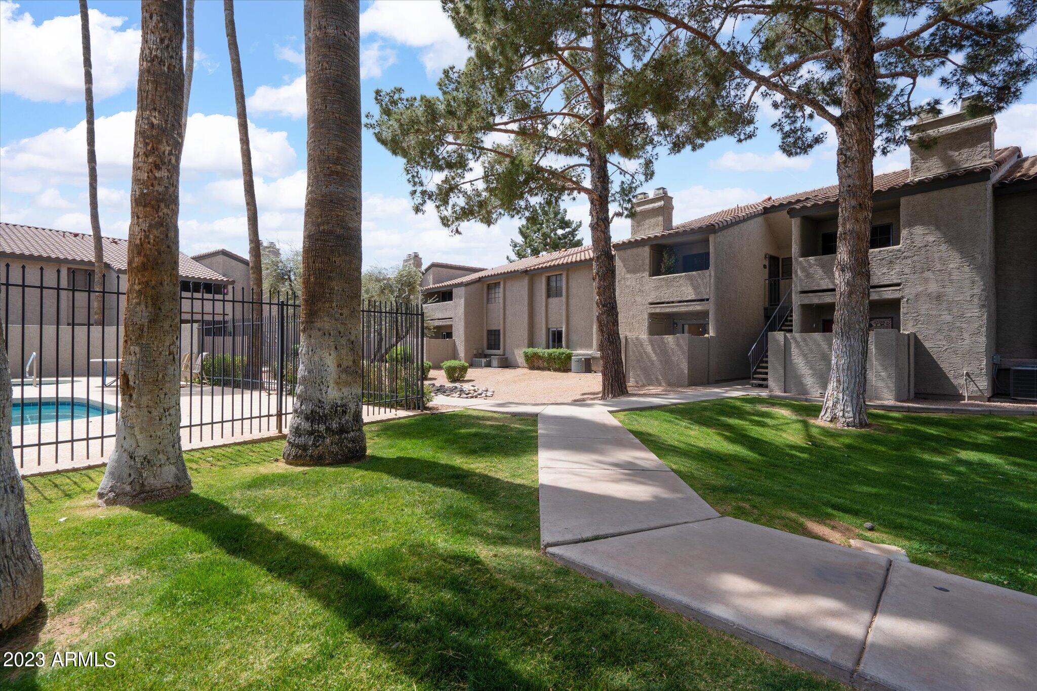 533 West Guadalupe Road, Unit 1024 Mesa, AZ 85210 - Photo 56 of 60 a view of a house with a yard and a large tree