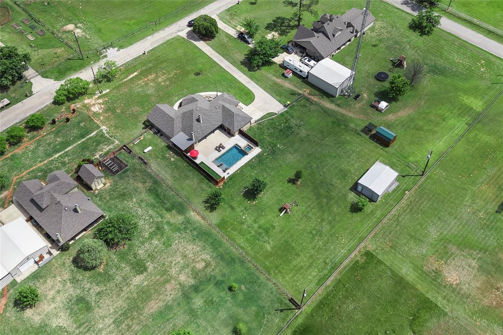 199 Newfield Lane Springtown, TX 76082 - Photo 38 of 38 This expansive property features extensive green lawn space, pool, putting green, playground, shop and a paved driveway.