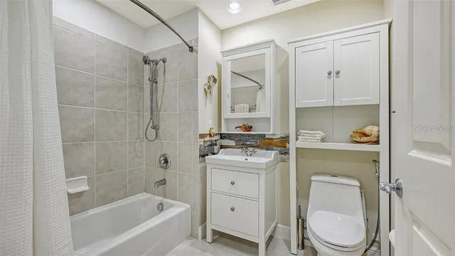 a bathroom with a granite countertop toilet a sink and bathtub