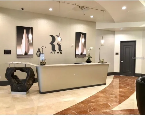 a living room with furniture and a large mirror