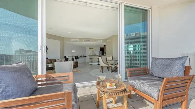 a living room with furniture and a floor to ceiling window