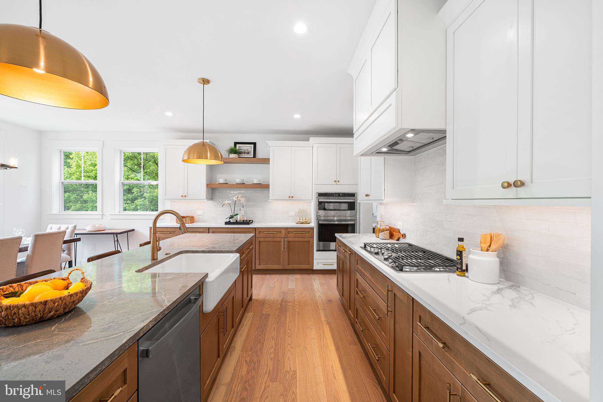 1813 Yost Road Blue Bell, PA 19422 - Photo 5 of 24 a large kitchen with stainless steel appliances granite countertop a sink a stove and a wooden floors