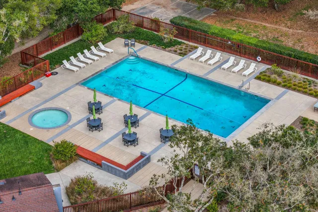 a view of a house with a backyard and a tree