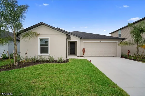 a front view of house with yard and green space