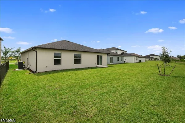 a view of a house with a backyard