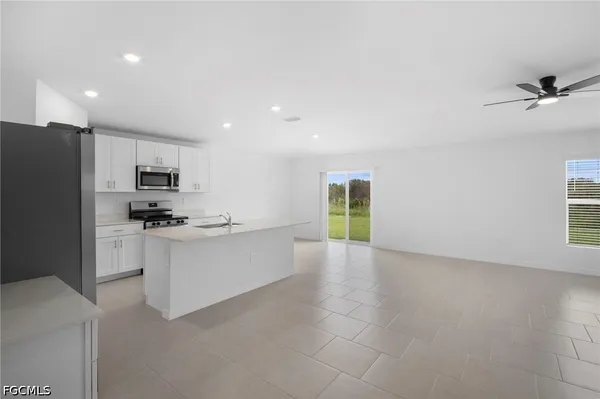 a kitchen with stainless steel appliances granite countertop a refrigerator sink and stove