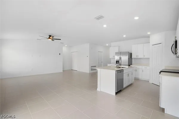 a kitchen with white cabinets and white appliances