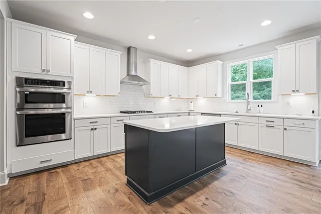 a kitchen with a sink stove and microwave