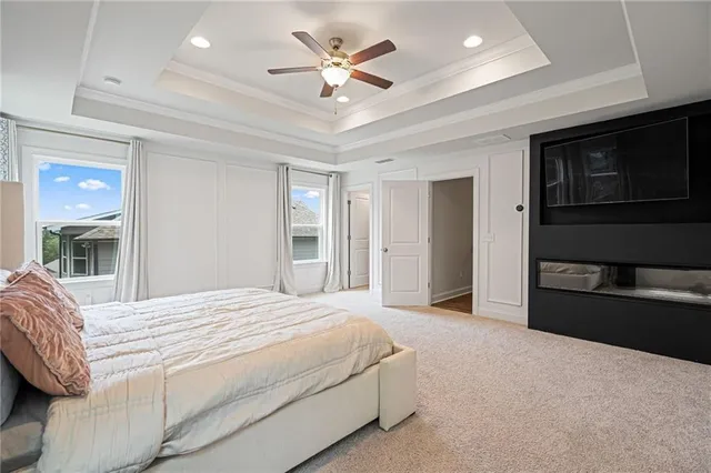 a spacious bedroom with a bed and a ceiling fan