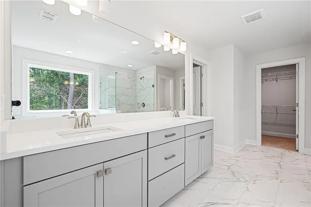 a bathroom with a sink vanity and mirror