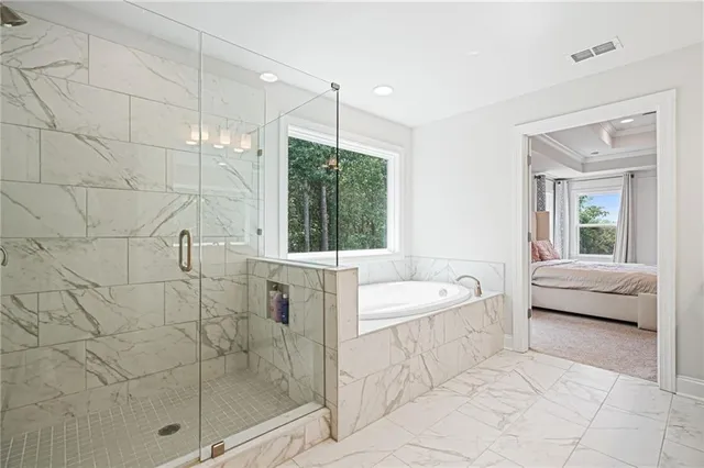 a spacious bathroom with a bathtub and a shower